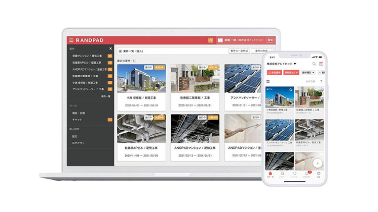 A laptop screen shows ANDPAD construction's interface.