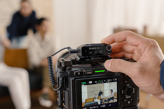 A Sony camera with Insta360 Mic Pro's transmitter mounted on top.