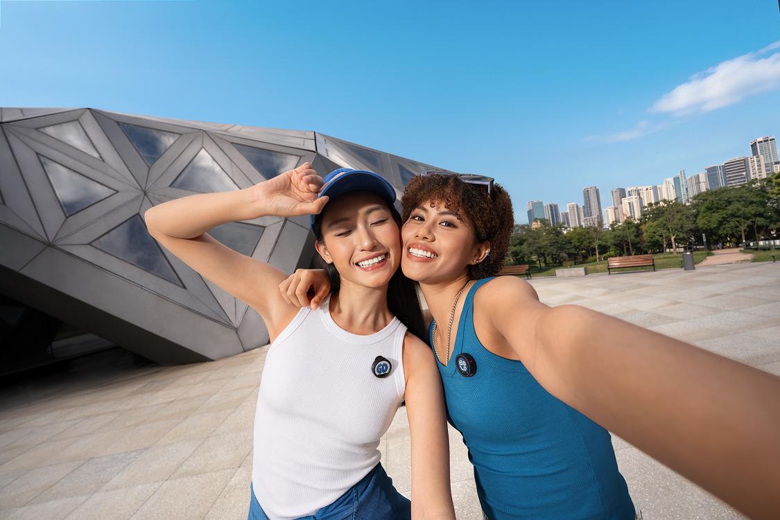 Two girls pose for a selfie with Mic Pro mounted.