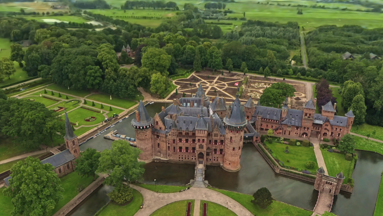 The fairytale-like neo-Gothic De Haar Castle near Utrecht, the largest castle in the Netherlands, featuring ornate towers and medieval-style architecture. Aerial footage shot on Antigravity A1.
