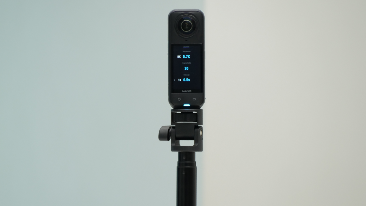An Insta360 X5 mounted onto a selfie stick for enterprise use.