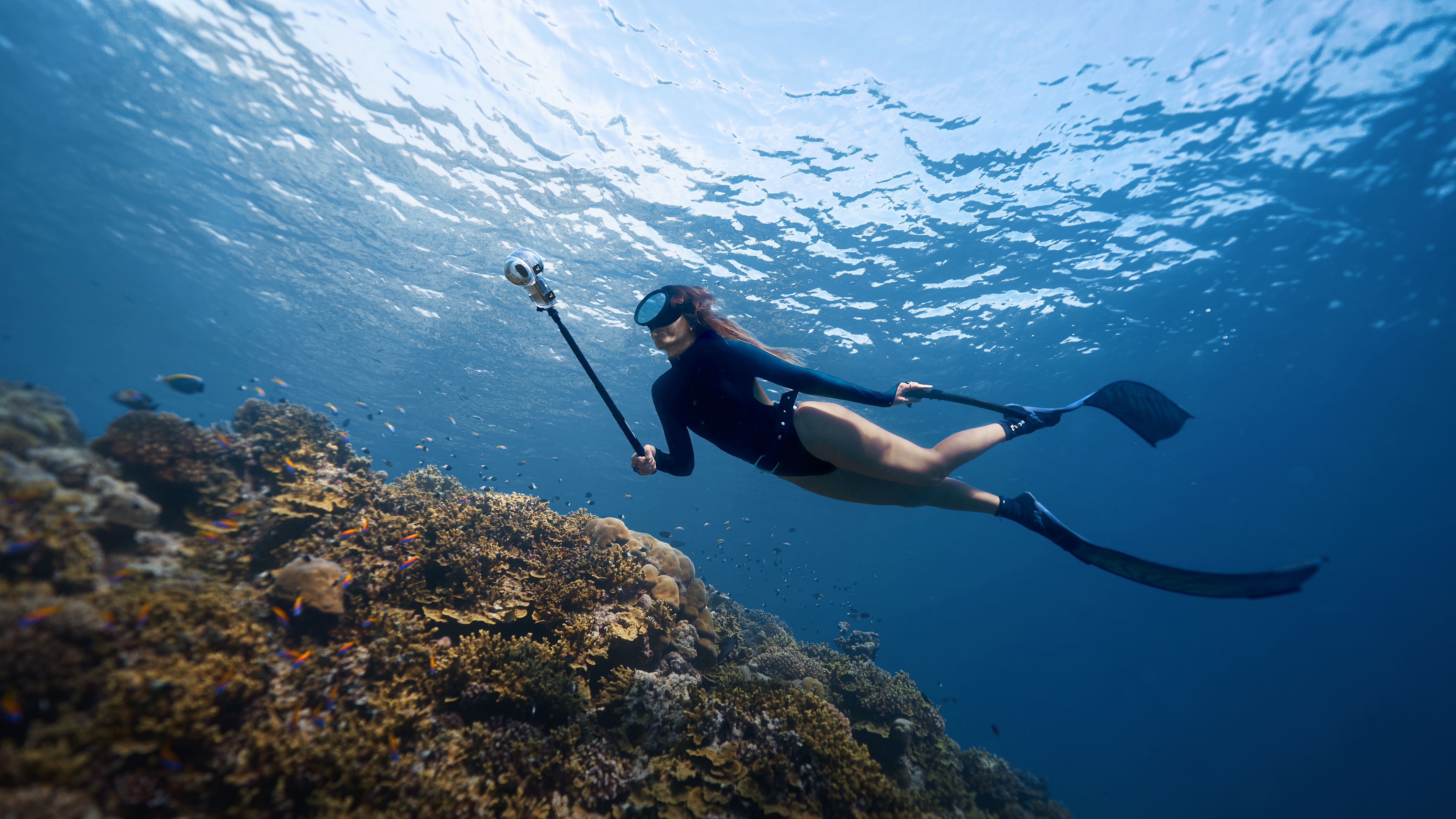 Diver recording underwater with an Insta360 camera