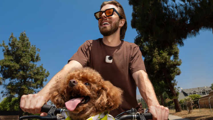 a man riding with a pet dog while wearing insta360 go ultra