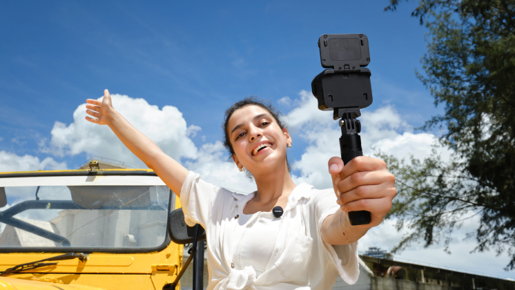 woman recording a vlog selfie with Insta360 Ace Pro 2's flip touchscreen