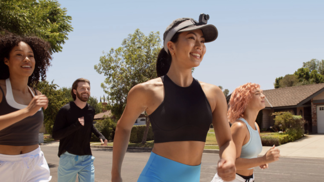 woman running with insta360 go ultra vlogging camera during a group run
